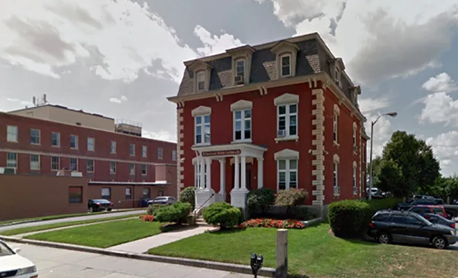 Historic red brick building with white trim